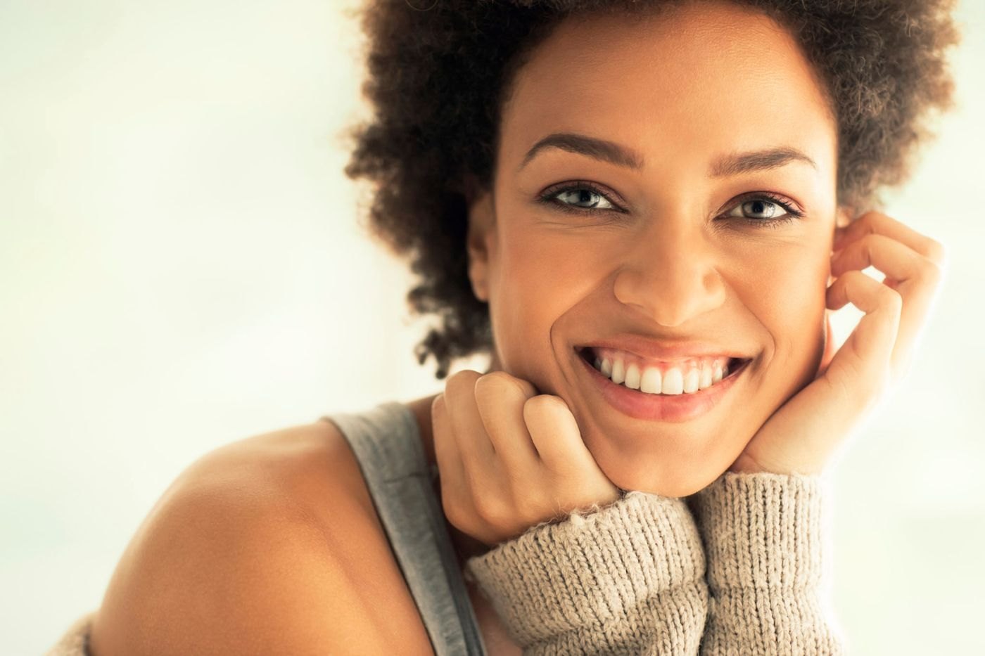 An adult with a warm, confident smile