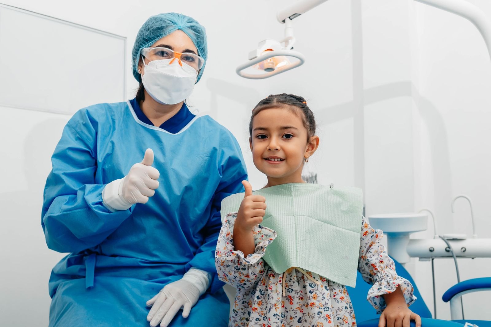 A child giving a thumbs up after a dental visit